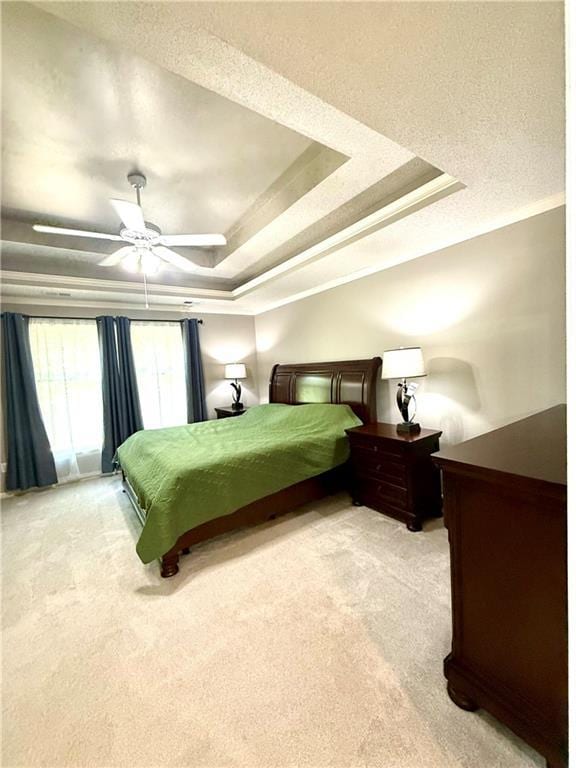 4531 Anderson St, Shawnee, KS 66226 - bedroom featuring light colored carpet, a raised ceiling, a ceiling fan, a textured ceiling, and ornamental molding