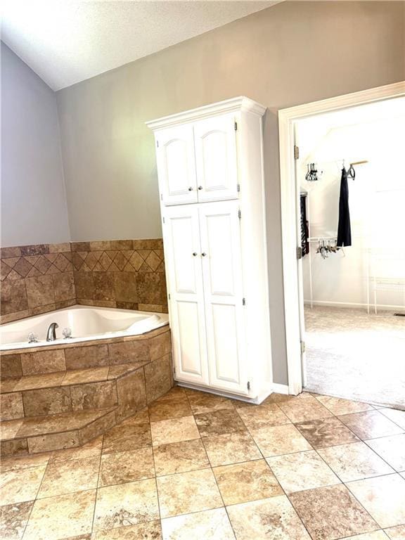 4531 Anderson St, Shawnee, KS 66226 - bathroom with a closet, a bath, and lofted ceiling