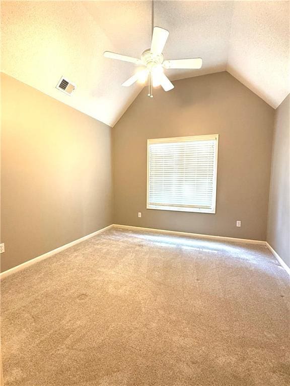 4531 Anderson St, Shawnee, KS 66226 - carpeted spare room featuring vaulted ceiling, a ceiling fan, and a textured ceiling