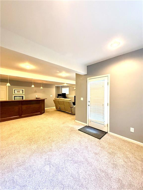 4531 Anderson St, Shawnee, KS 66226 - unfurnished living room featuring light colored carpet and baseboards