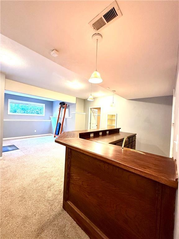 4531 Anderson St, Shawnee, KS 66226 - bar featuring carpet floors and decorative light fixtures