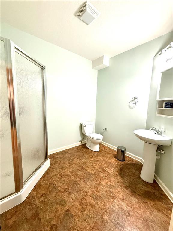 4531 Anderson St, Shawnee, KS 66226 - bathroom featuring a shower stall and tile patterned floors