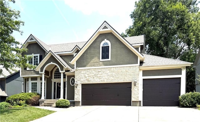 4531 Anderson St, Shawnee, KS 66226 - craftsman house featuring stucco siding, driveway, stone siding, an attached garage, and roof with shingles