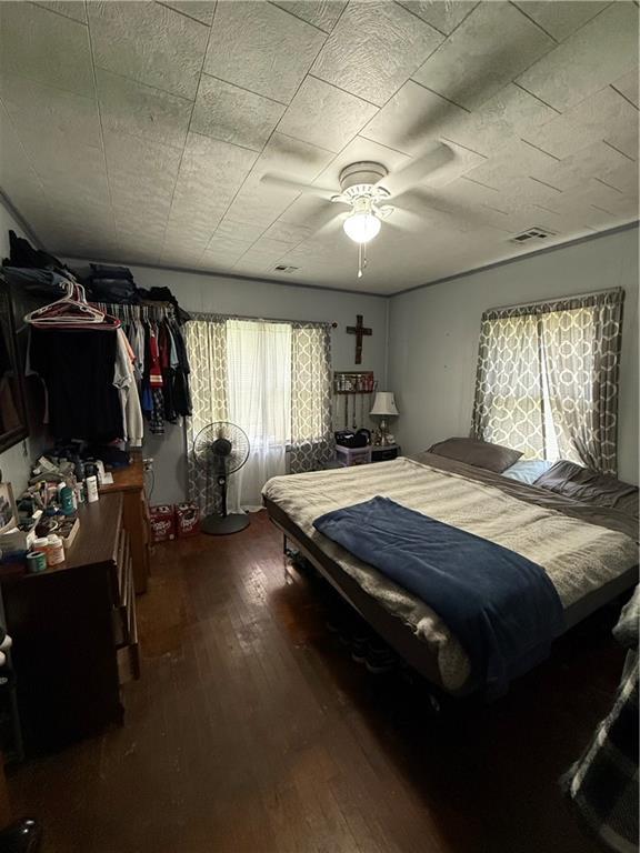704 W 2nd St, Coffeyville, KS 67337 - bedroom featuring wood-type flooring and ceiling fan