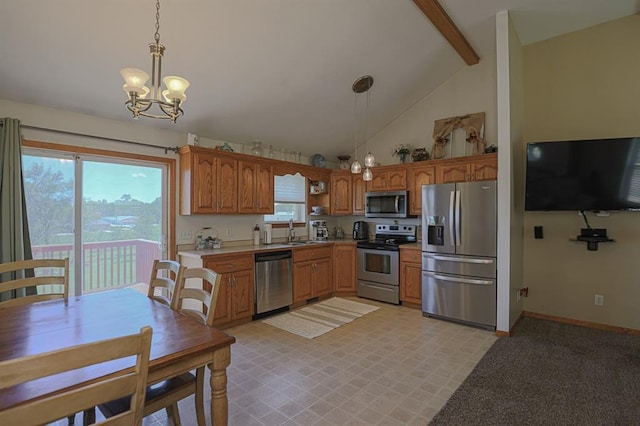 127 Hondo St, Lathrop, MO 64465 - kitchen featuring appliances with stainless steel finishes, hanging light fixtures, a chandelier, brown cabinetry, and light countertops