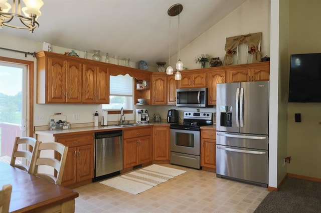 127 Hondo St, Lathrop, MO 64465 - kitchen featuring stainless steel appliances, lofted ceiling, brown cabinets, a chandelier, and pendant lighting