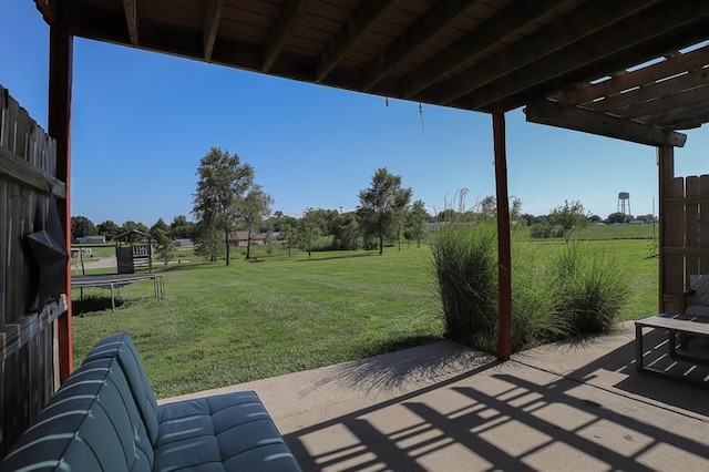 127 Hondo St, Lathrop, MO 64465 - view of patio / terrace featuring a trampoline, a pergola, and a view of rural / pastoral area