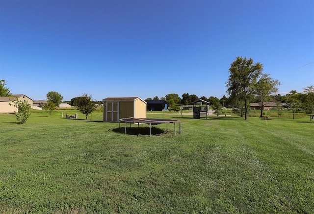 127 Hondo St, Lathrop, MO 64465 - view of grassy yard featuring a shed and a trampoline