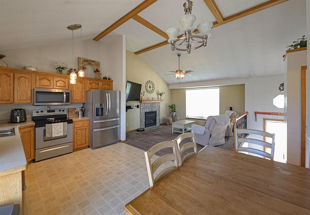 127 Hondo St, Lathrop, MO 64465 - kitchen featuring stainless steel appliances, a chandelier, a tile fireplace, light countertops, and pendant lighting