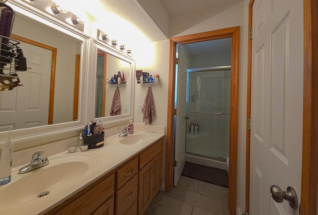 127 Hondo St, Lathrop, MO 64465 - bathroom featuring tile patterned floors, a stall shower, and double vanity