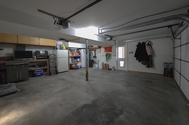 127 Hondo St, Lathrop, MO 64465 - garage with a garage door opener and freestanding refrigerator