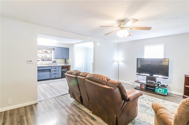 516 W 7th St, Carrollton, MO 64633 - living room with a ceiling fan and light wood-style floors