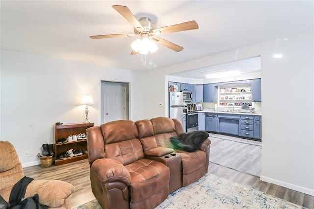 516 W 7th St, Carrollton, MO 64633 - living room featuring light wood-style floors and a ceiling fan