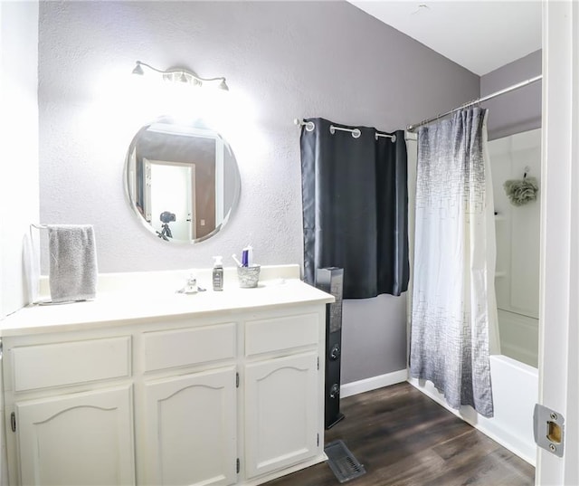 516 W 7th St, Carrollton, MO 64633 - full bathroom with vanity, shower / tub combo, and wood finished floors