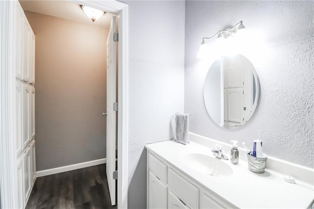 516 W 7th St, Carrollton, MO 64633 - bathroom featuring vanity and wood finished floors
