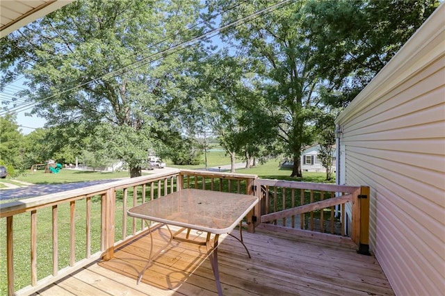 516 W 7th St, Carrollton, MO 64633 - wooden deck featuring a playground and a yard