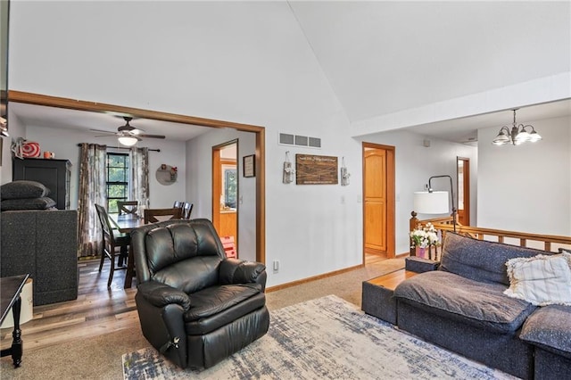 11579 Earnshaw St, Overland Park, KS 66210 - carpeted living area featuring high vaulted ceiling, a ceiling fan, and a chandelier