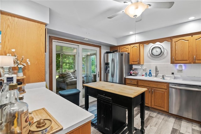 11579 Earnshaw St, Overland Park, KS 66210 - kitchen with stainless steel appliances, light countertops, ceiling fan, and light wood-style flooring
