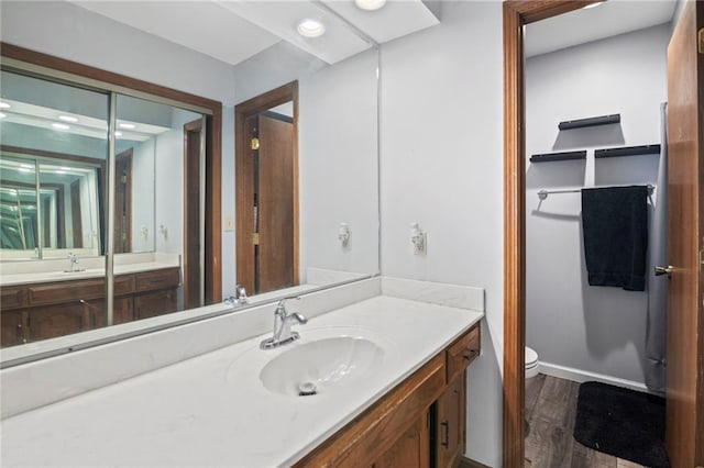 11579 Earnshaw St, Overland Park, KS 66210 - bathroom featuring vanity, wood finished floors, and recessed lighting