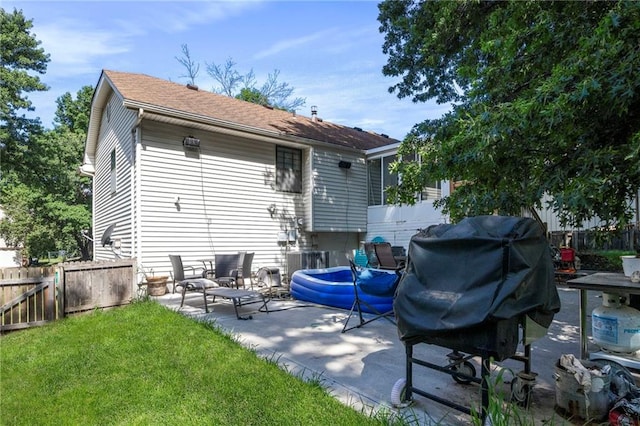 11579 Earnshaw St, Overland Park, KS 66210 - back of property with a patio area and a shingled roof