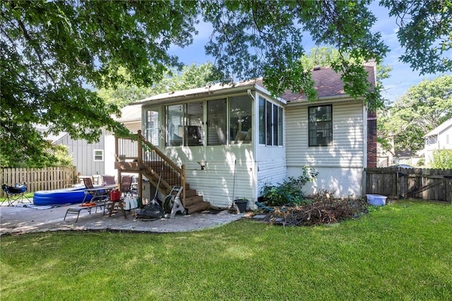 11579 Earnshaw St, Overland Park, KS 66210 - rear view of house with a sunroom, a patio area, a fenced backyard, and stairs