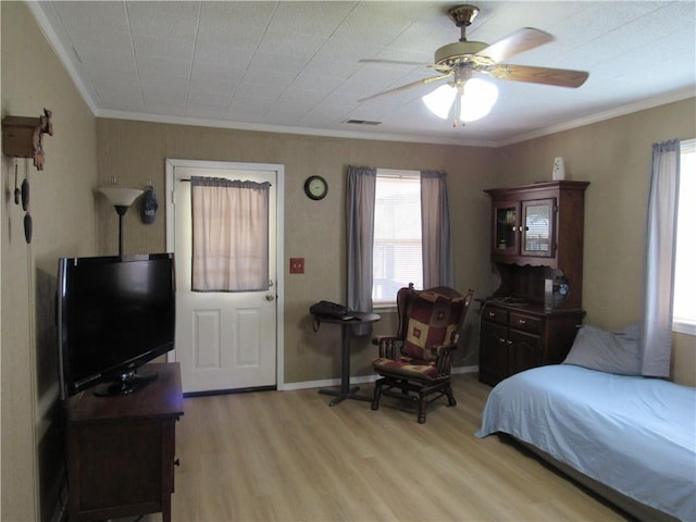 706 W 10th St, Sedalia, MO 65301 - bedroom with wood finished floors, crown molding, and ceiling fan