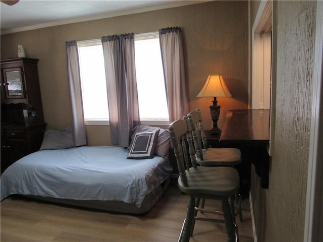 706 W 10th St, Sedalia, MO 65301 - bedroom featuring wood finished floors and ornamental molding