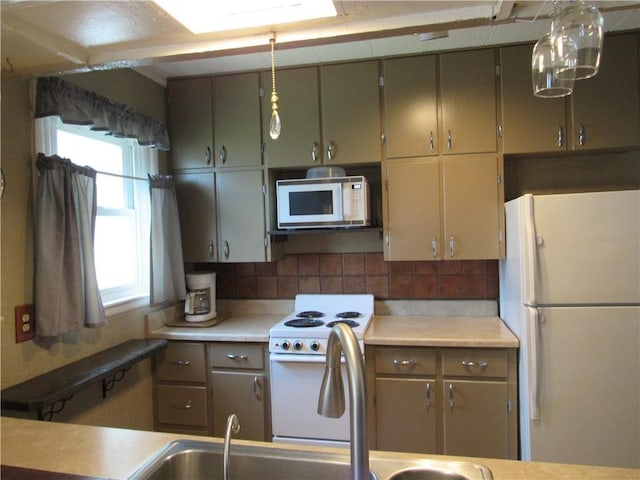 706 W 10th St, Sedalia, MO 65301 - kitchen with white appliances, light countertops, and tasteful backsplash