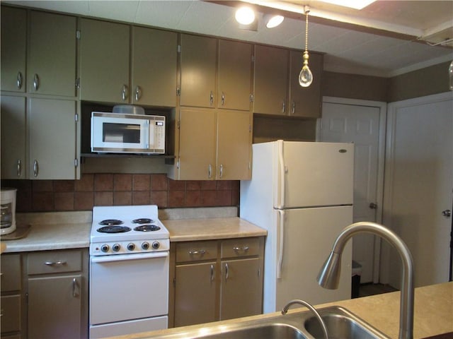 706 W 10th St, Sedalia, MO 65301 - kitchen featuring white appliances, decorative backsplash, and light countertops