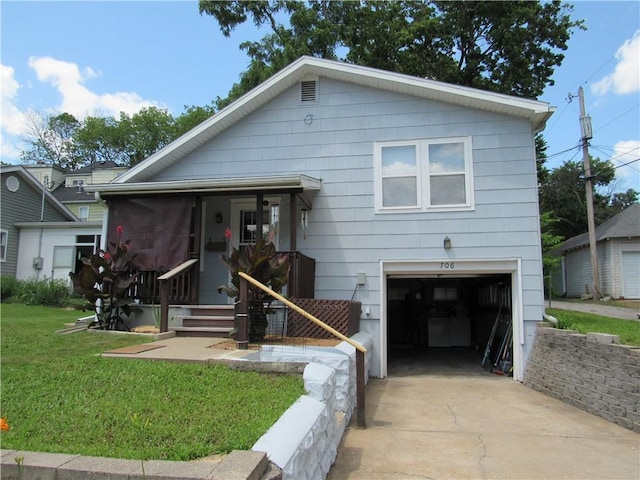 706 W 10th St, Sedalia, MO 65301 - view of front of house featuring an attached garage, driveway, and a front lawn