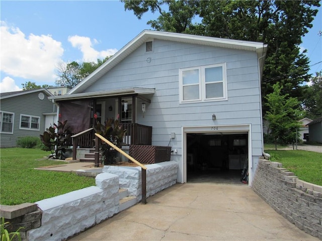 706 W 10th St, Sedalia, MO 65301 - view of front facade featuring a garage, concrete driveway, and a front yard