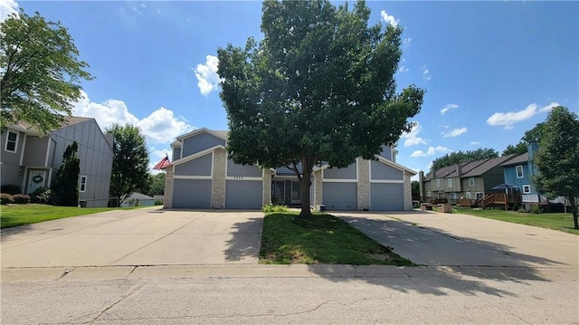 2604 S Peck Ct Unit B, Independence, MO 64055 - obstructed view of property with driveway, a residential view, and brick siding