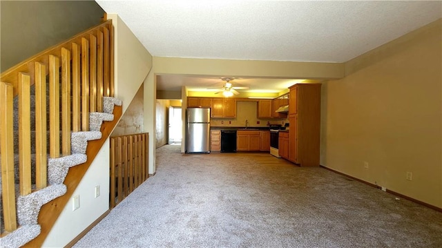 2604 S Peck Ct Unit B, Independence, MO 64055 - unfurnished living room featuring light carpet, ceiling fan, stairs, and a textured ceiling