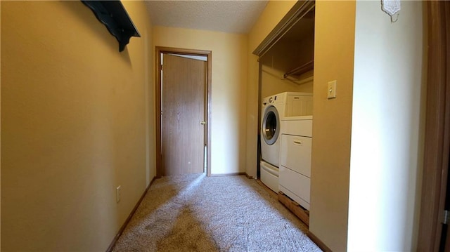 2604 S Peck Ct Unit B, Independence, MO 64055 - laundry area featuring independent washer and dryer, light carpet, and a textured ceiling