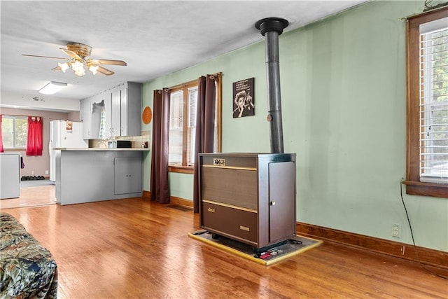 1234 S Pearl St, Independence, MO 64055 - living area featuring wood finished floors, a ceiling fan, and plenty of natural light
