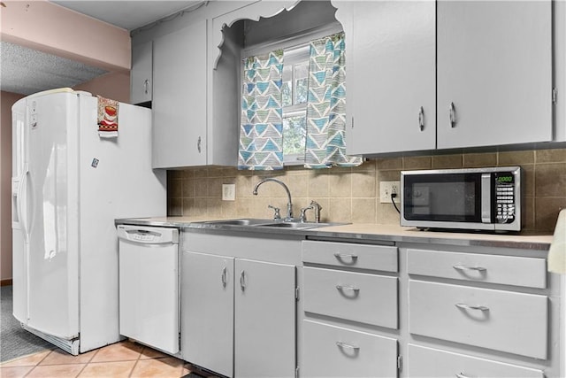 1234 S Pearl St, Independence, MO 64055 - kitchen with white appliances, backsplash, light countertops, and light tile patterned floors