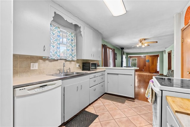 1234 S Pearl St, Independence, MO 64055 - kitchen with white appliances, light countertops, light tile patterned floors, and decorative backsplash