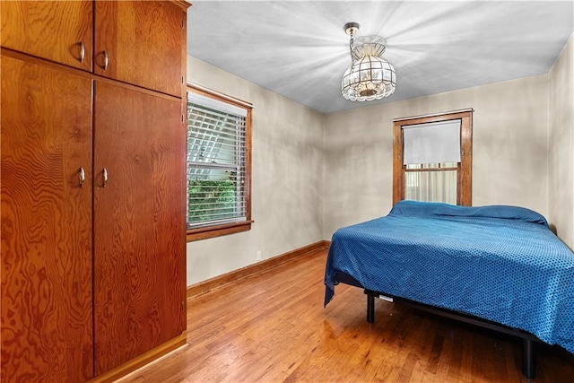 1234 S Pearl St, Independence, MO 64055 - bedroom featuring light wood-type flooring and a chandelier