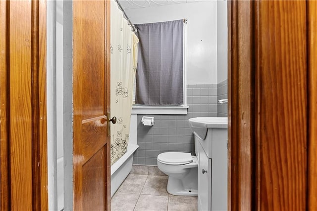 1234 S Pearl St, Independence, MO 64055 - full bathroom featuring tile patterned flooring, tile walls, vanity, and a wainscoted wall