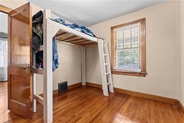 1234 S Pearl St, Independence, MO 64055 - unfurnished bedroom featuring hardwood / wood-style flooring