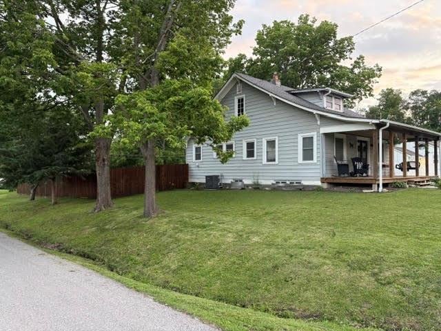 383 E Broadway St, Peculiar, MO 64078 - view of property exterior with a wooden deck and a chimney
