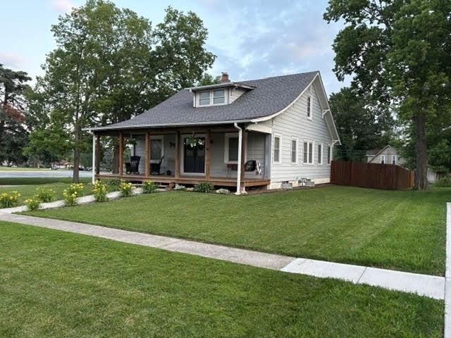 383 E Broadway St, Peculiar, MO 64078 - view of front of property featuring covered porch and a chimney