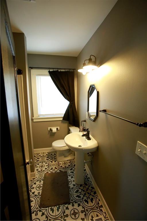 383 E Broadway St, Peculiar, MO 64078 - bathroom with baseboards and tile patterned floors