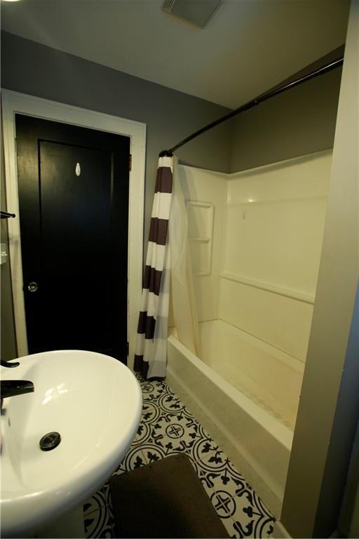 383 E Broadway St, Peculiar, MO 64078 - full bath featuring tile patterned floors and shower / bath combination with curtain