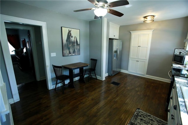 383 E Broadway St, Peculiar, MO 64078 - dining space with dark wood-type flooring and ceiling fan