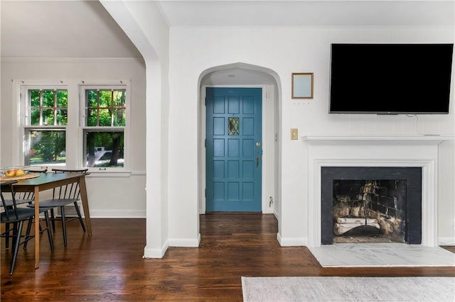 6347 Sni A Bar Rd, Kansas City, MO 64129 - living area with wood finished floors, ornamental molding, a fireplace, and arched walkways