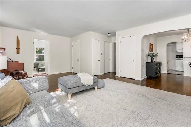 6347 Sni A Bar Rd, Kansas City, MO 64129 - living room featuring arched walkways and dark wood finished floors