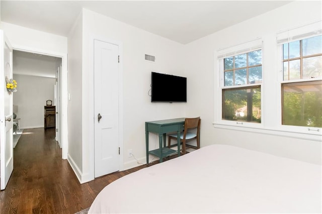 6347 Sni A Bar Rd, Kansas City, MO 64129 - bedroom with dark wood-type flooring and baseboards
