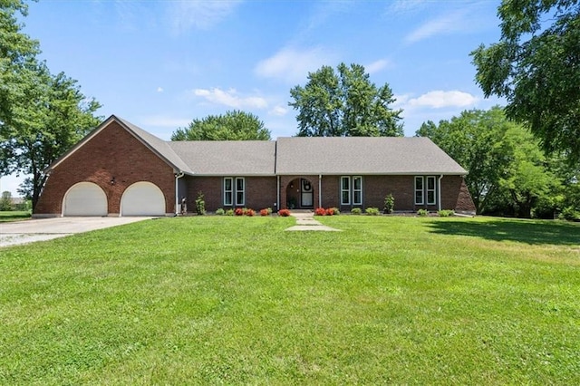 1803 N Jeter Rd, Raymore, MO 64083 - ranch-style home with an attached garage, brick siding, a front lawn, and concrete driveway