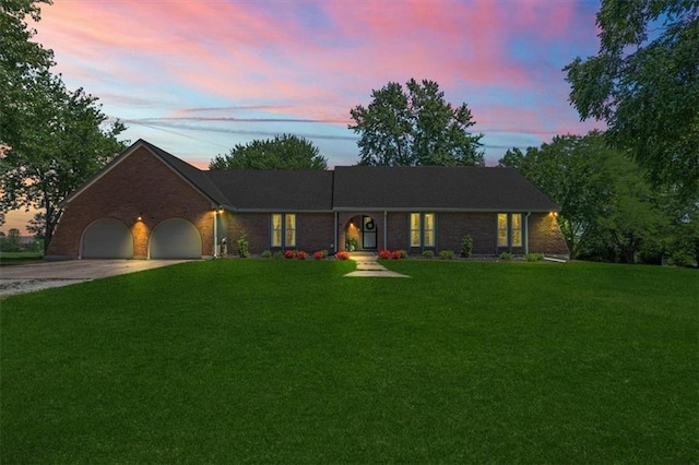 1803 N Jeter Rd, Raymore, MO 64083 - ranch-style house with driveway, a garage, a front lawn, and brick siding